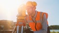 Construction Worker Using Theodolite Surveying Optical Instrument for Measuring Angles in Horizont Royalty Free Stock Photo