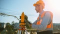 Construction Worker Using Theodolite Surveying Optical Instrument for Measuring Angles in Horizont Royalty Free Stock Photo