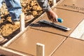 Construction Worker Using Trowel On Wet Cement Forming Coping Around New Pool Royalty Free Stock Photo