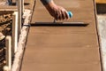 Construction Worker Using Trowel On Wet Cement Forming Coping Around New Pool Royalty Free Stock Photo