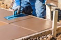 Construction Worker Using Trowel On Wet Cement Forming Coping Around New Pool Royalty Free Stock Photo