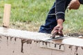 Construction Worker Using Wood Trowel On Wet Cement Forming Coping Around New Pool Royalty Free Stock Photo