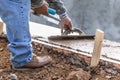 Construction Worker Using Wood Trowel On Wet Cement Forming Coping Around New Pool Royalty Free Stock Photo