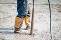 worker vibrating cement slab. Worker using concrete vibrator Royalty Free Stock Photo