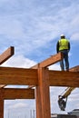 Construction worker walks on beams of a wood building Royalty Free Stock Photo