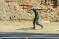 A construction worker walks hastily in the scorching sun. Royalty Free Stock Photo