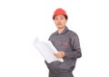 A construction worker wearing a red hard hat is holding drawing in front of a white background Royalty Free Stock Photo