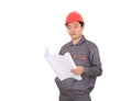 A construction worker wearing a red hard hat is holding drawing in front of a white background Royalty Free Stock Photo