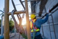 Construction worker wearing safety harness and safety line working at high place, Fall arrestor device for worker with hooks for Royalty Free Stock Photo