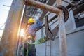 Construction worker wearing safety harness and safety line working at high place, Fall arrestor device for worker with hooks for Royalty Free Stock Photo