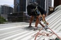 Worker wearing safety harness using secondary safety device connecting into 10.5 mm static rope