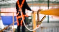 Construction worker wearing safety harness working at high place Royalty Free Stock Photo