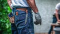 Construction worker wearing tool belt and gloves on a building site Royalty Free Stock Photo