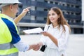 Client shaking hand with builder after signing contract