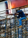 A Construction Worker welding steel bars.