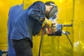 The construction worker welding the steel tube.