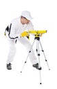 Construction worker in white coveralls level tool Royalty Free Stock Photo