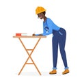 Construction worker woman in hard hat standing at wooden table to write