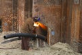 Construction Worker at work and repairing some steel pipes