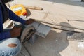 Construction worker work in the sunlight during the daytime. Use a circular saw to cutting wood Royalty Free Stock Photo