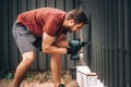 construction worker working with cordless screwdriver fastening screws in metal elements