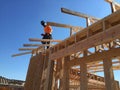 Construction worker working on the framing process for a new a house.