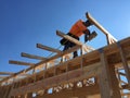 Construction worker working on the framing process for a new a house.