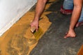 Construction worker working on installing the parquets on the floor