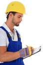Construction worker writing on clipboard Royalty Free Stock Photo