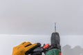 Man with orange gloves using an electric drill on a wall Royalty Free Stock Photo
