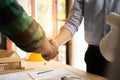 Construction workers, architects and engineers shake hands while working for teamwork and cooperation after completing an Royalty Free Stock Photo