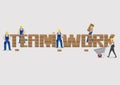 Construction Workers Building Brick Wall to Form Teamwork Text V