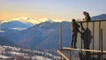 Construction workers building a house in the mountains. Two construction workers assembling a metal roof on a house Royalty Free Stock Photo