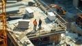 Construction workers are on a building site, overseeing the progress of a highrise project. AIG53M Royalty Free Stock Photo