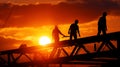 Construction workers building steel frame structure at sunset Royalty Free Stock Photo