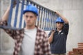 Construction Workers Carrying Ladder Royalty Free Stock Photo