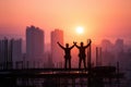 Construction Workers Celebrating Sunset View from High-Rise Building Site Royalty Free Stock Photo