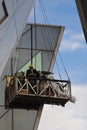 Construction workers in the check outer wall glass Royalty Free Stock Photo