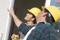 Construction Workers Checking Window Royalty Free Stock Photo