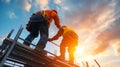 Construction workers collaborating on scaffolding against a dramatic sunset sky Royalty Free Stock Photo