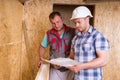 Construction Workers Consulting Plans in New Home Royalty Free Stock Photo