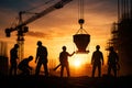 Construction Workers Coordinating Concrete Pour With Crane During Sunset Royalty Free Stock Photo