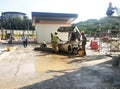 Construction workers creating concrete road curb at the construction site.