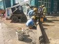 Construction workers creating concrete road curb at the construction site.