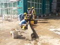 Construction workers creating concrete road curb at the construction site.