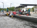 Construction workers creating concrete road curb at the construction site.