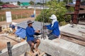 Construction workers are creating the pillar blocks in the project