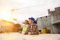 Construction workers discussing job at building site