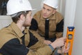 Construction workers discussing plan building in office Royalty Free Stock Photo