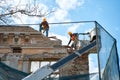 Construction workers dismantle the old building to build a new one